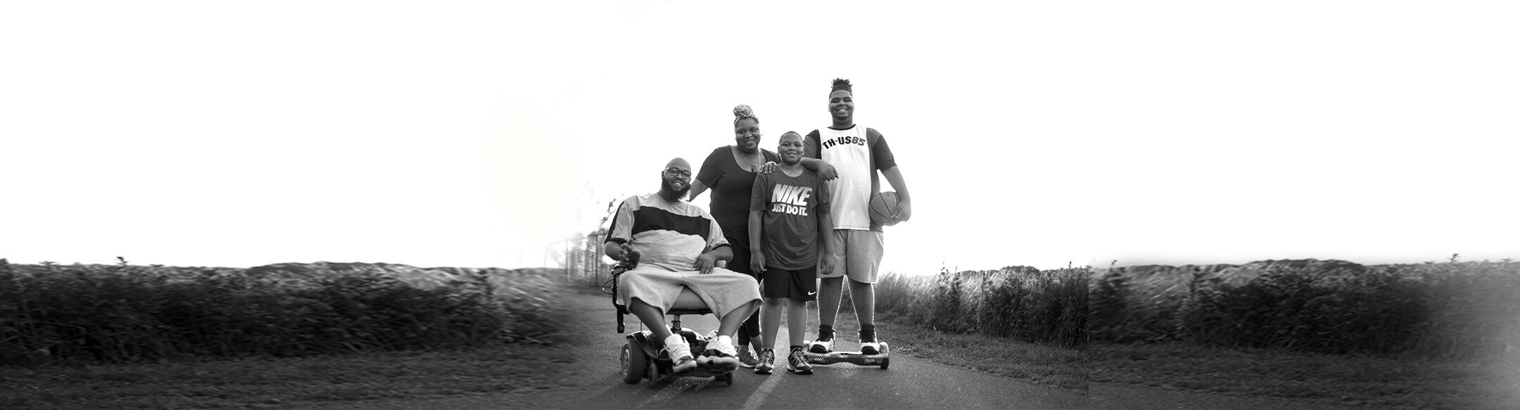 Princeton patient living with Pompe disease sitting in a wheelchair with his family